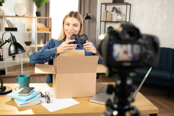 istock Woman recording video while unpacking box with joystick 1390131409