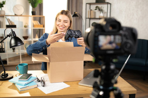 istock Woman recording video while unpacking box with joystick 1390131417