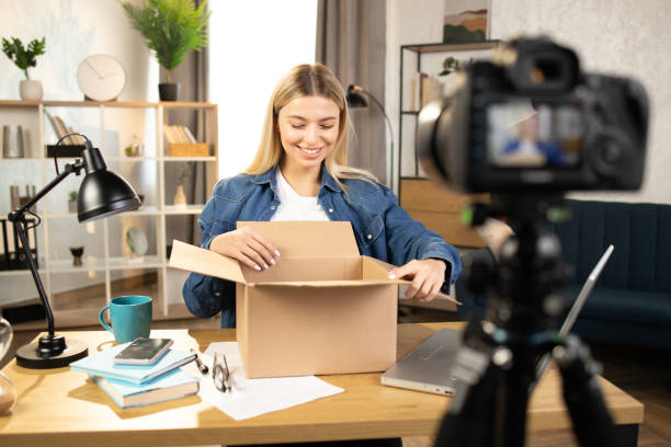 istock Caucasian woman doing live stream while unpacking parcel 1390131450