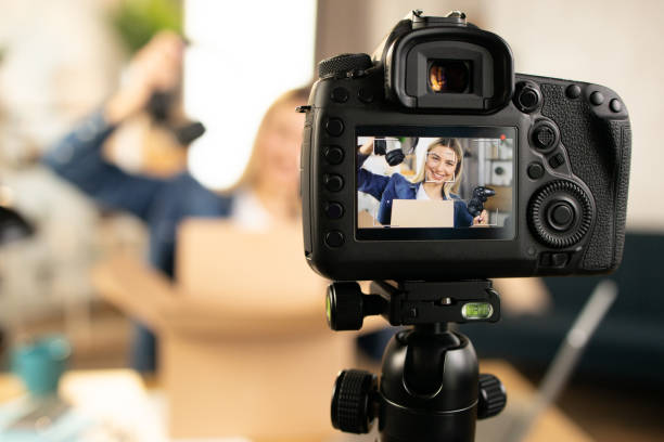 istock Young female blogger doing live stream while unpacking box 1390131500