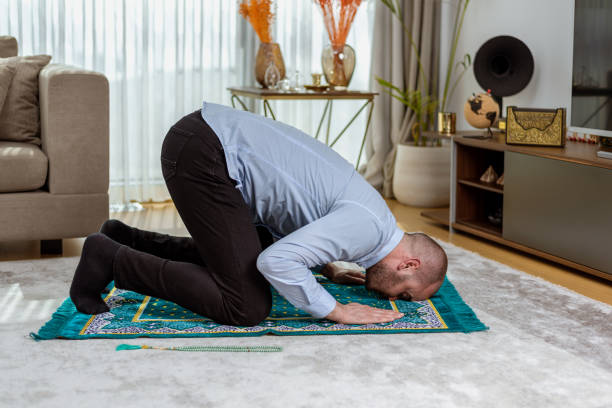 istock Muslim man prostrates peacefully during prayer. 1390131520