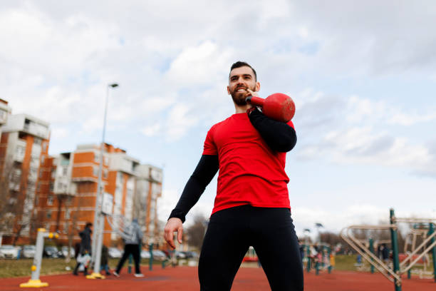 Burning calories and strengthening his core with a kettlebell