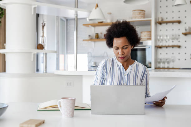 istock Mid adult woman working from home 1390132903
