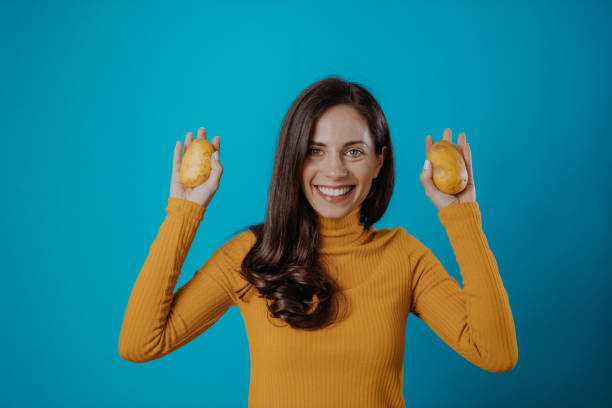 Vegetable Young woman holding vegetables smiling potato stock pictures, royalty-free photos & images