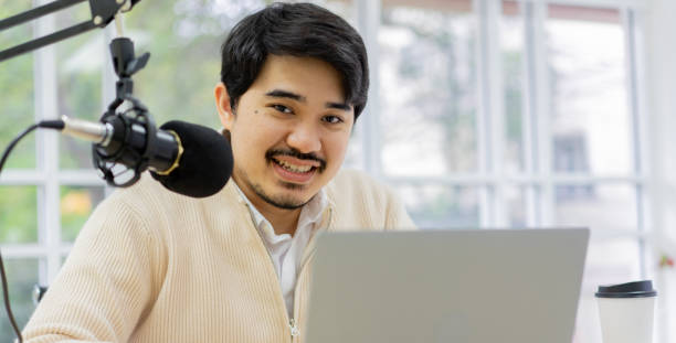istock close up young middle eastern man talking on microphone to start explain and share about news or inspired content to motivation audience at home office for millennial lifestyle concept 1390133151