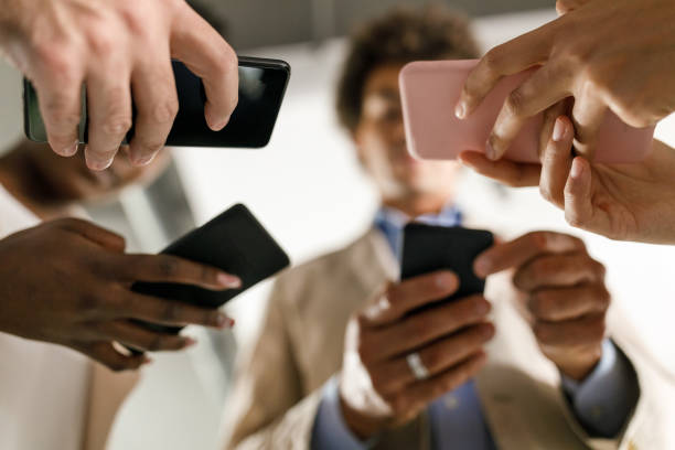 istock Directly below shot of business colleagues exchanging mobile data with each other 1390133910