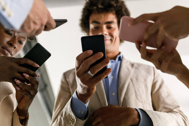 istock Diverse group of business colleagues exchanging mobile data 1390133914