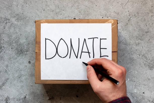 sulla scatola con donazioni, raccolta fondi, aiuti umanitari scrive la parola donazione - jar currency donation box charity and relief work foto e immagini stock