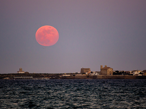 Strawberry moon over the island of Tabarca, Alicante, Spain