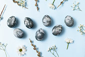 Blue Easter eggs on light blue background for banner design. Beautiful spring card. Happy easter concept.