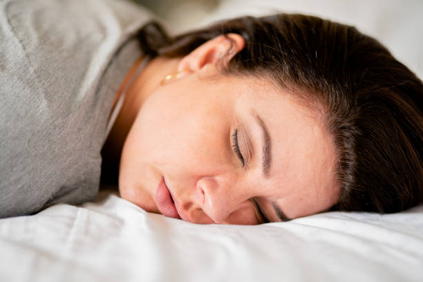 istock Woman sleeping face down on her bed in the morning 1390140182