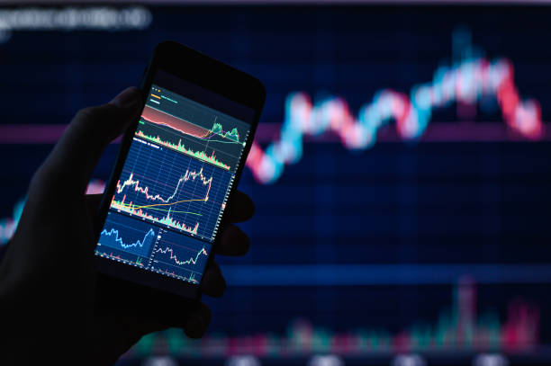 istock Background on a financial theme. Trader charts on smartphone. 1390142579