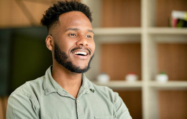 istock Young businessman smiling while standing in an office 1390142781