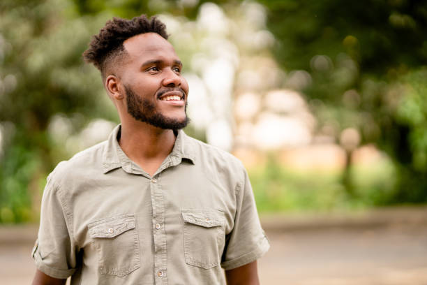 istock Smiling young man standing outside in the summertime 1390142906