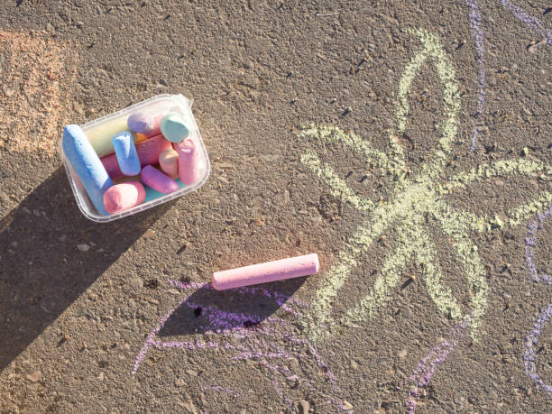 istock children's drawings with chalk on the pavement and scattered chalk 1390143044