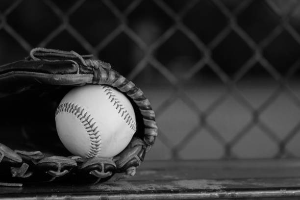 istock Baseball glove with ball in dugout 1390144246