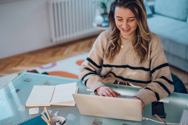 istock Woman working from a home on her a laptop 1390145944