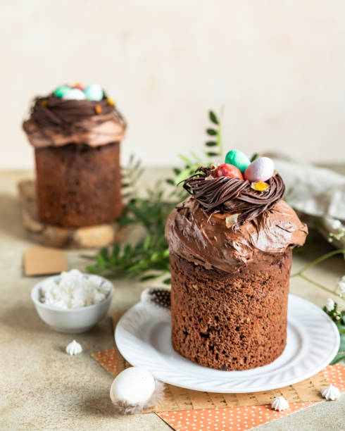 istock Traditional Orthodox Easter chocolate sweet bread or cake with chocolate nests and eggs on ceramic plate. Easter composition with chocolate Kulich, eggs and flowers. 1390147640