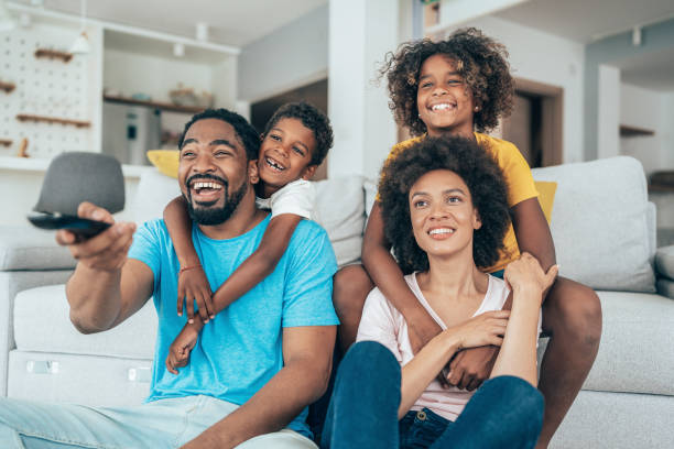 istock Family watching television 1390148356