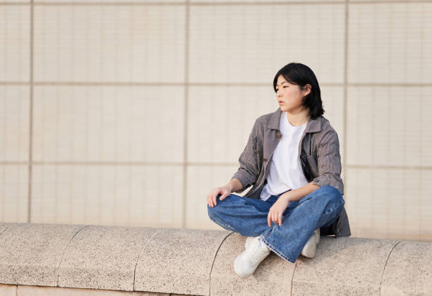 istock Young asian woman sitting. 1390150817