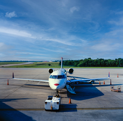 White jet passenger plane seen from the front waiting on tarmac