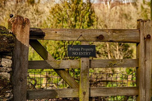 Old country wooden gate with private sign on it