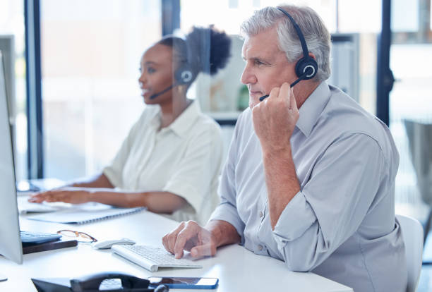 istock Shot of a mature call centre agent working on a computer in an office 1390152850