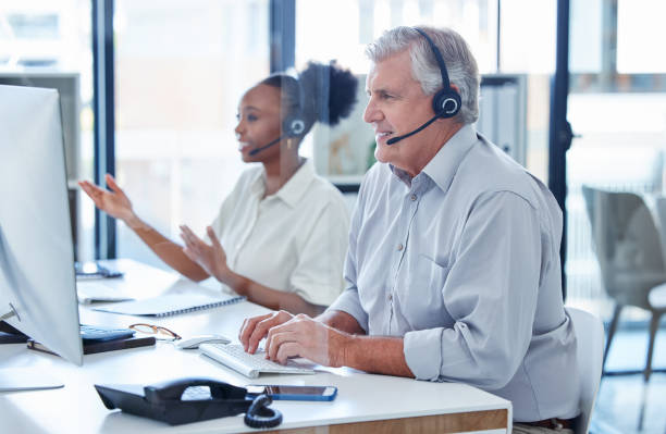 istock Shot of a mature call centre agent working on a computer in an office 1390152857