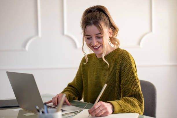 istock Woman working from a home on her a laptop 1390153017