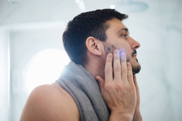 istock Handsome Man Checking his Appearance in a Bathroom 1390155858