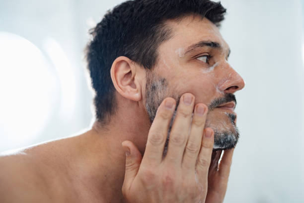 istock Handsome Man Washing his Face in the Bathroom 1390155873