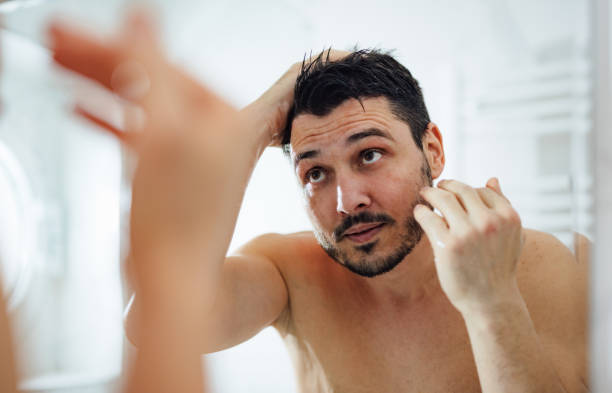 istock Handsome Man Styling his Hair in a Bathroom 1390155884