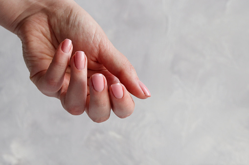 Neat nude manicure. Fashion and beauty, minimalism. Close-up.