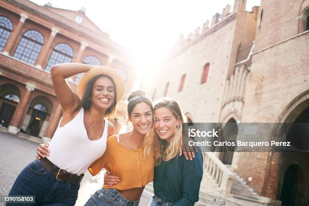 Three Happy Female Friends Having Fun Outdoors In Summer Vacations At City Portrait Of Smiling Woman Hugging Looking At Camera Together Stock Photo - Download Image Now