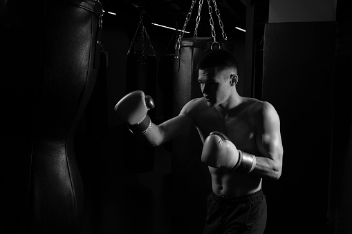 A and on grunt beats background a black Boxer black white photo strength shadow fight victory, for hit boxer from one for strong lifestyle, male young. Bag muscle black, guy grayscale