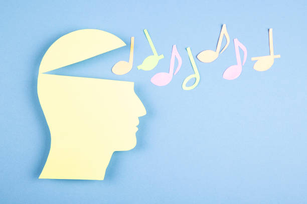 istock Human head in paper cut style and  music notes 1390159017