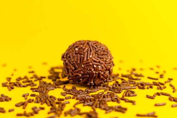 istock Brigadeiro isolated on yellow background 1390159782