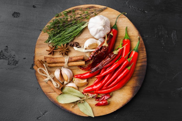 istock Garlic cloves and spices on black background 1390159800