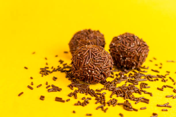 istock Group of brigadeiros on yellow background 1390159804