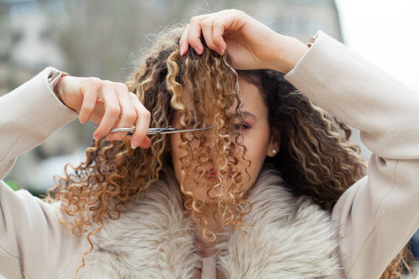 Young woman having her hair cut