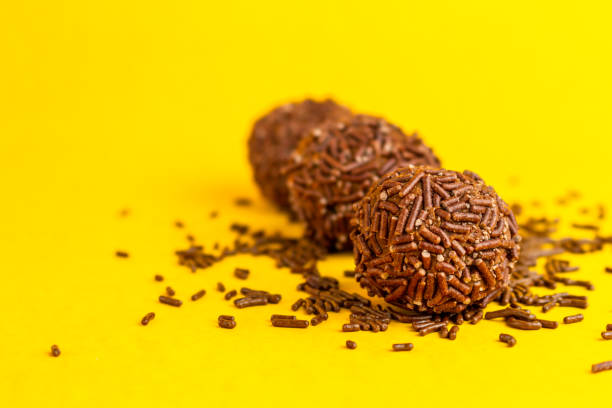 istock Brigadeiros lined up on a yellow background 1390159819