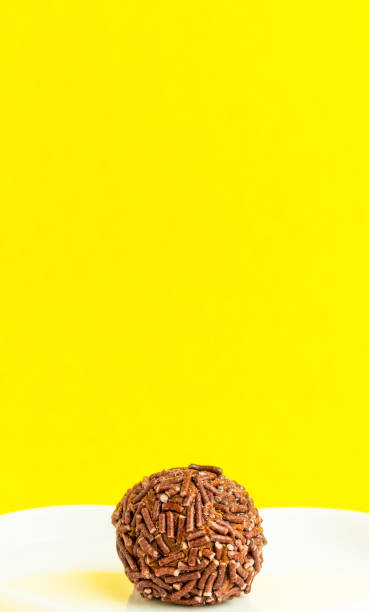 istock Brigadeiro isolated on yellow background with copy space. 1390159820