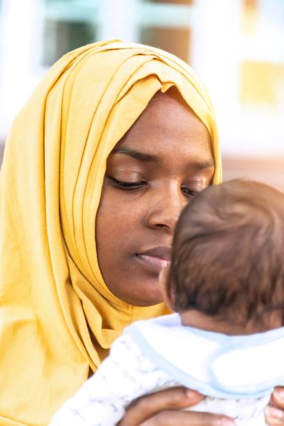 istock Black Muslim mother holding her baby 1390159934