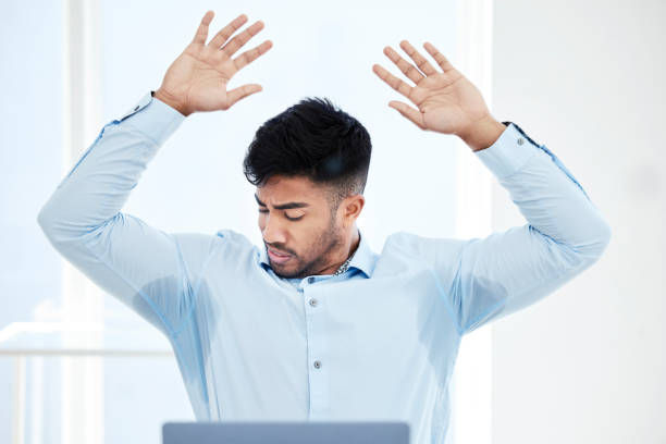 Shot of a young businessman with sweat stained through the underarms of his shirt All sweaty and stressed underarm stock pictures, royalty-free photos & images