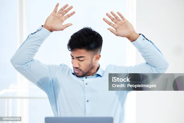 Shot Of A Young Businessman With Sweat Stained Through The Underarms Of His Shirt Stock Photo - Download Image Now