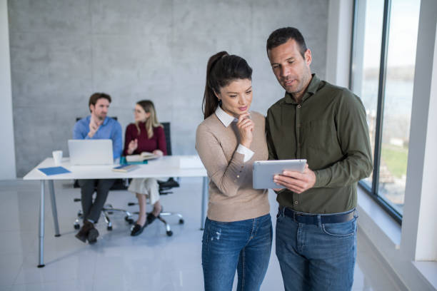 istock Business colleagues using a digital tablet and cooperating in office. 1390160687