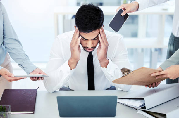 istock Shot of a young businessman looking stressed out while working in a demanding office environment 1390160708