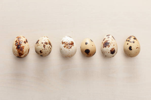 istock quail eggs arranged on white wooden background 1390162623