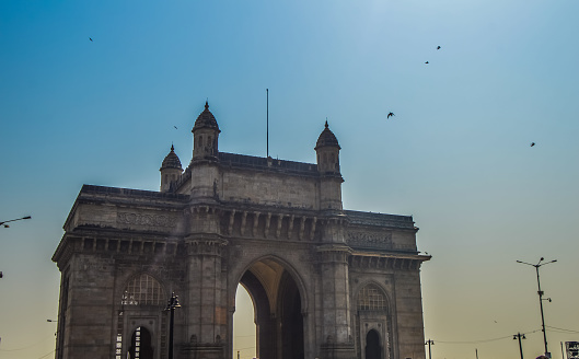 Beautiful Gateway of India near Taj Palace hotel on the Mumbai harbour with many jetties on Arabian sea near Chhatrapati Shivaji monument