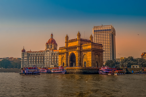 Beautiful Gateway of India near Taj Palace hotel on the Mumbai harbour with many jetties on Arabian sea near Chhatrapati Shivaji monument